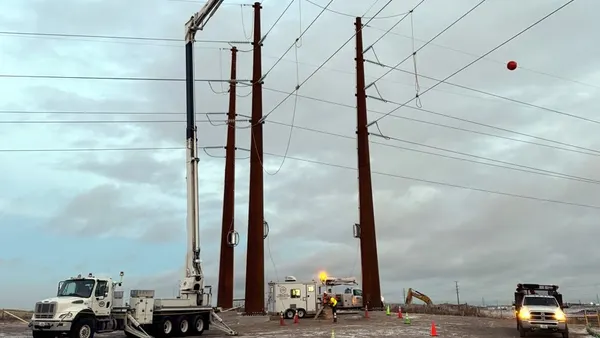 A utility crew works on a power line.