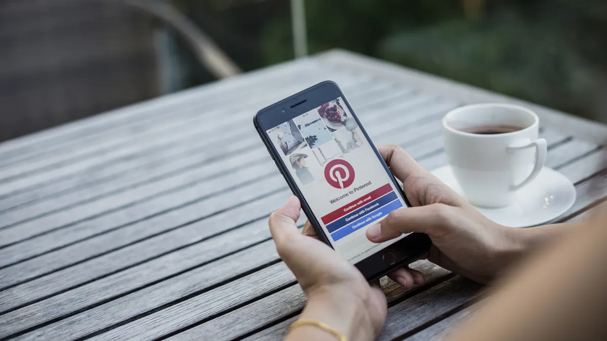A person looks at the Pinterest app on their phone.