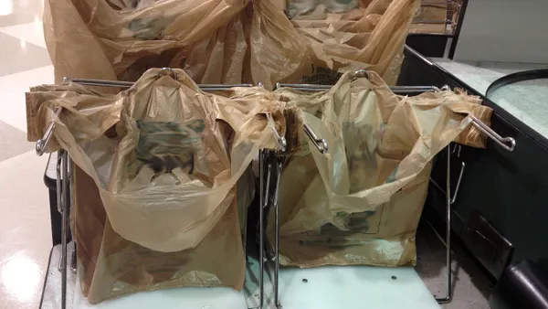 tan plastic bags at a grocery store checkout
