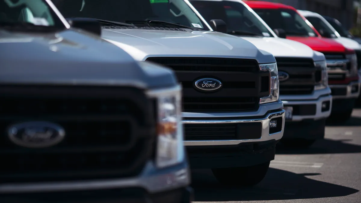 New Ford trucks parked outside at a dealership in Long Beach, California.