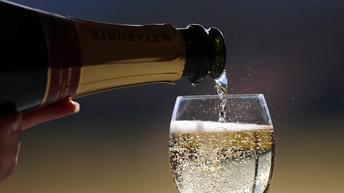 A photo of wine being poured into a glass.