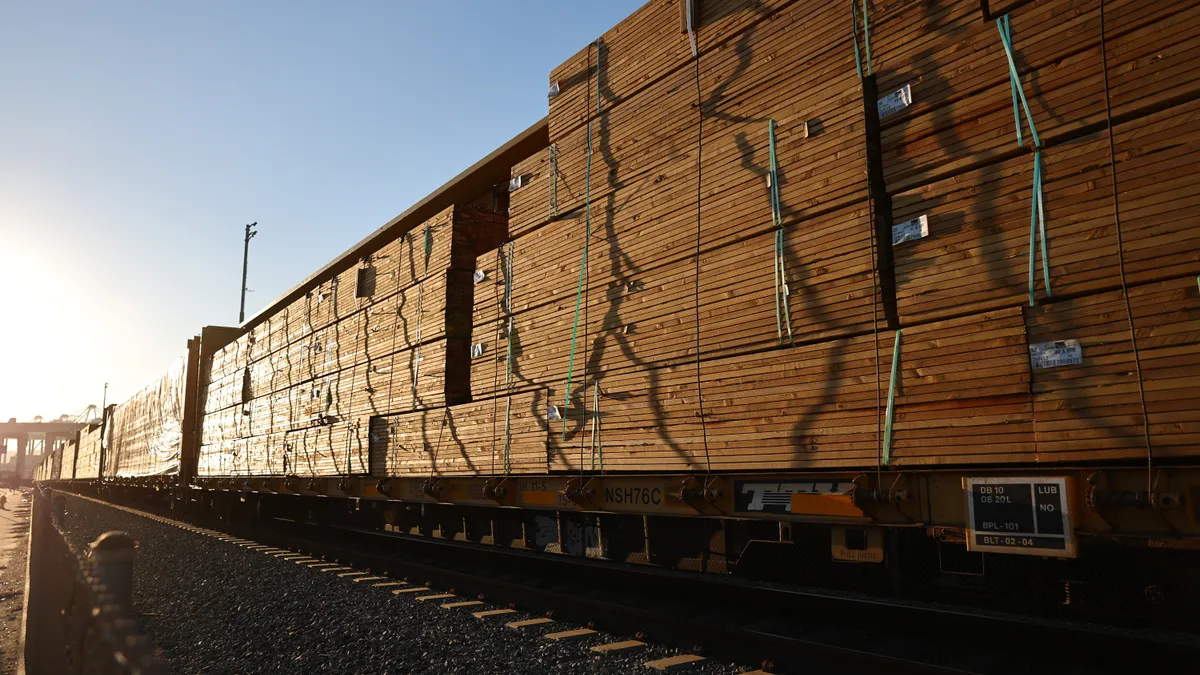 Freight rail cars loaded with lumber sit on tracks at the Port of Los Angeles