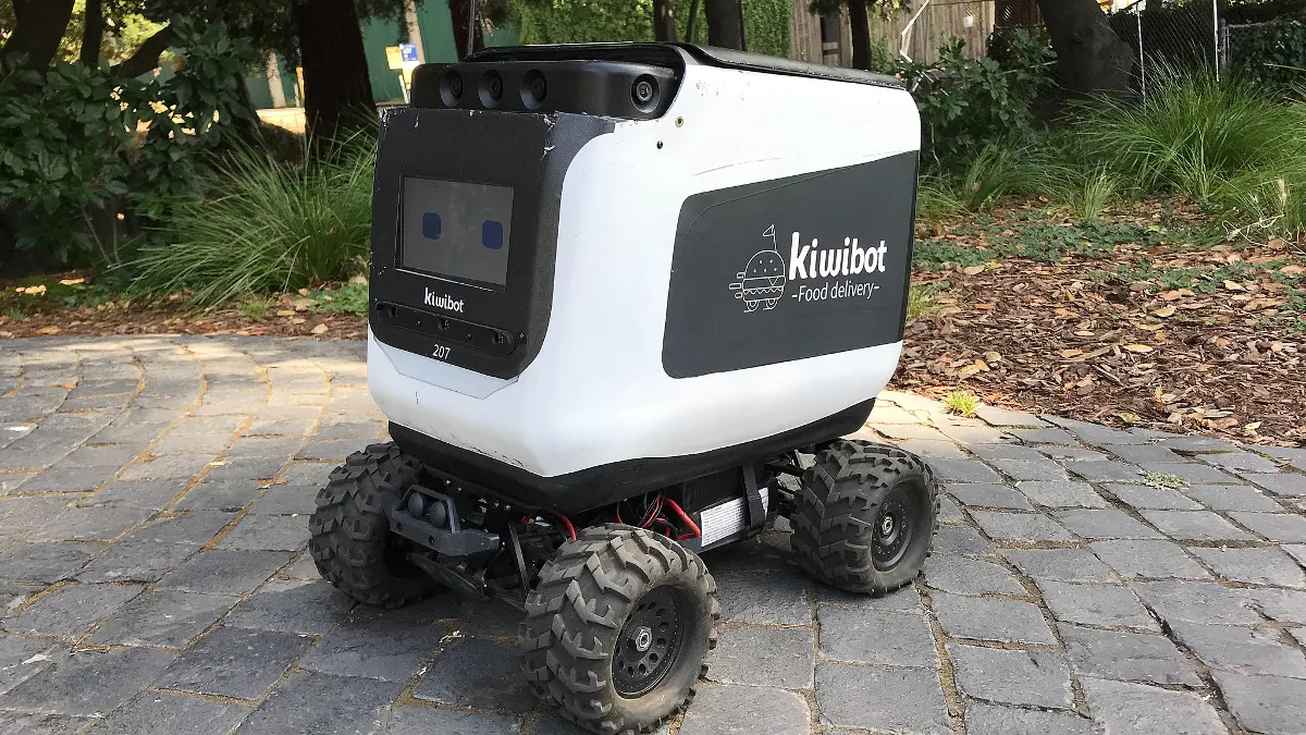 Front view of a Kiwibot food delivery robot, taken at University of California, Berkeley at the western end of Grinnel Pathway.