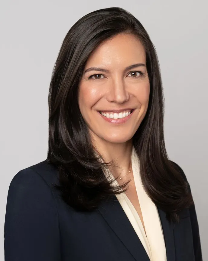 Headshot of a woman in business attire.