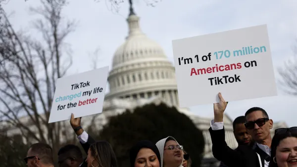 Participants holding signs in support of TikTok outside the U.S. Capitol Building.