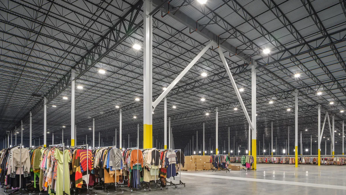 A rental brand's fulfillment center with a racks of clothes.