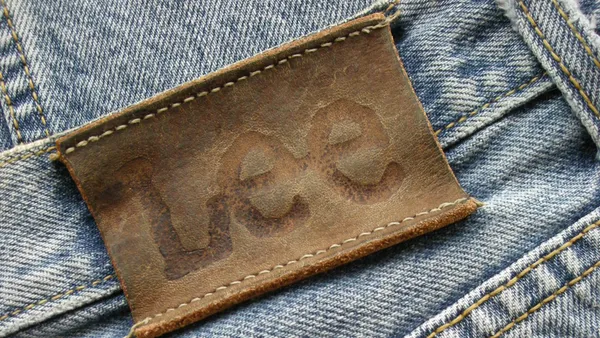 A closeup of a pair of Lee blue jeans, showing the label.