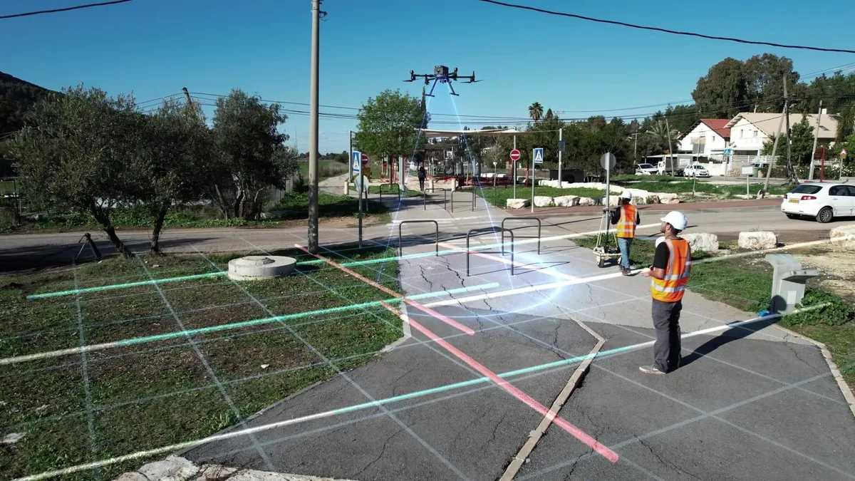 Worker in construction hat and reflective vest flies a drone, which hovers above an overlay of bright lines indicating utilities underground.