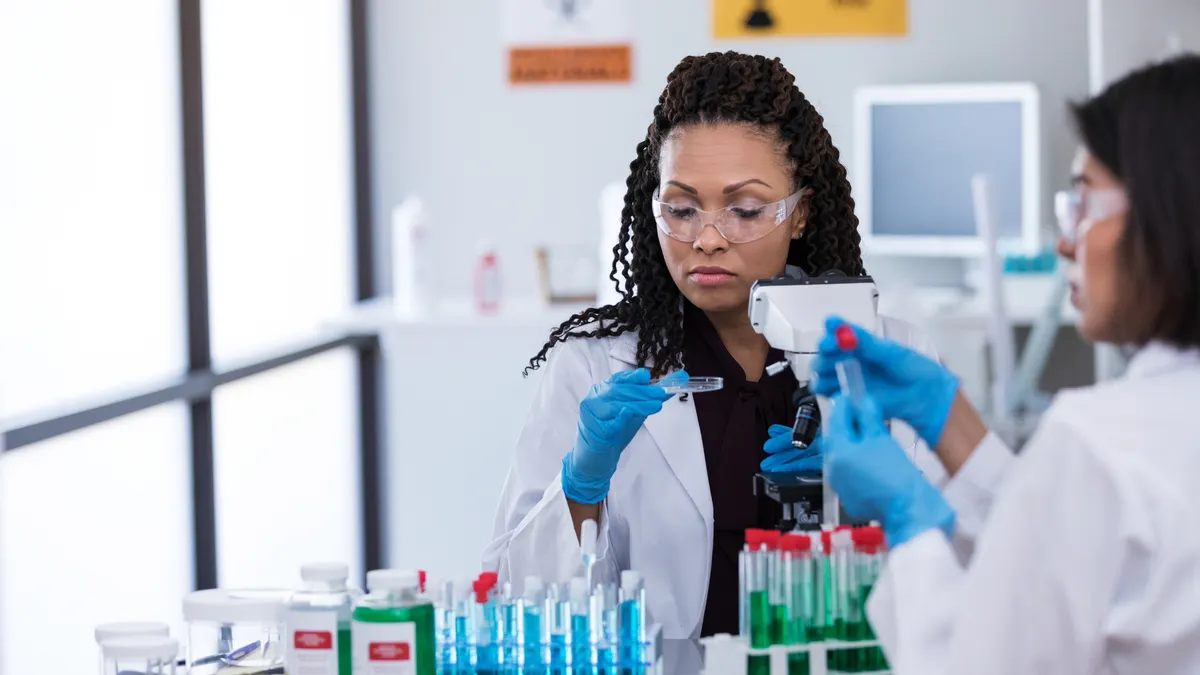 Confident mid adult female scientists work together in a laboratory.