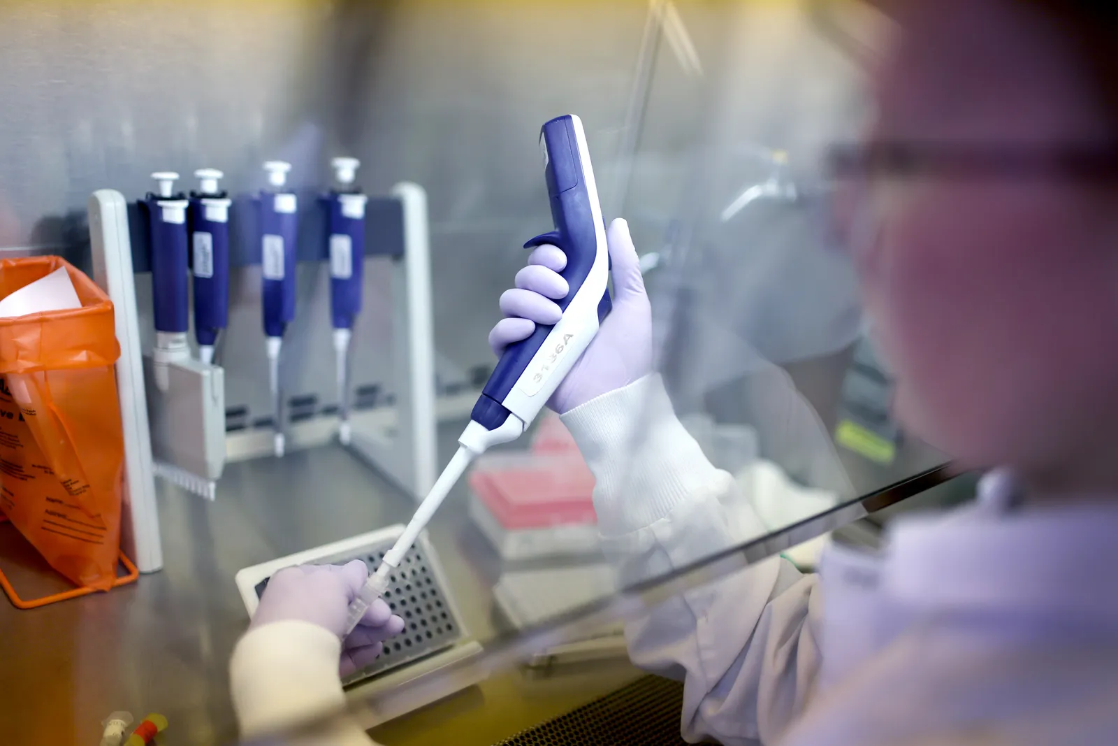 A person uses a instrument to collect samples.