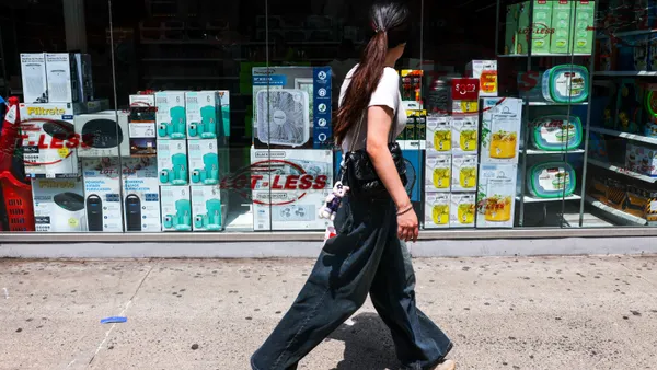 A person walks past a storefront.