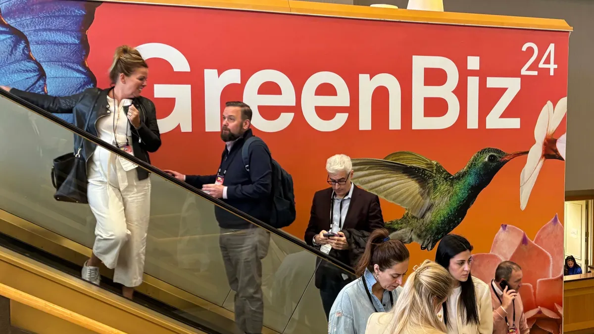 Conference attendees seen in front of GreenBiz24 logo.