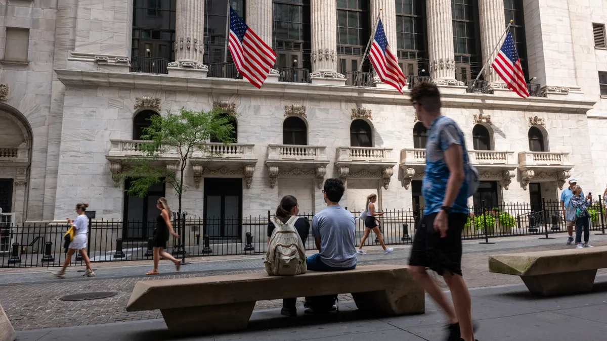 Shot of people walking past the NYSE on Monday July 22, 2024