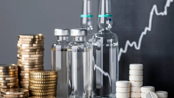 Drugs and piles of money with an ascending curve as a symbol for rising prices of pharmaceutical stocks.