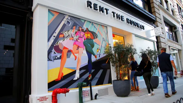 People pass by a Rent the Runway store.