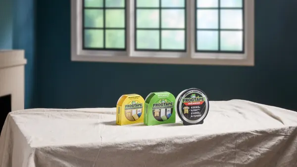 Three containers holding different varieties of FrogTape brand painter's tape.