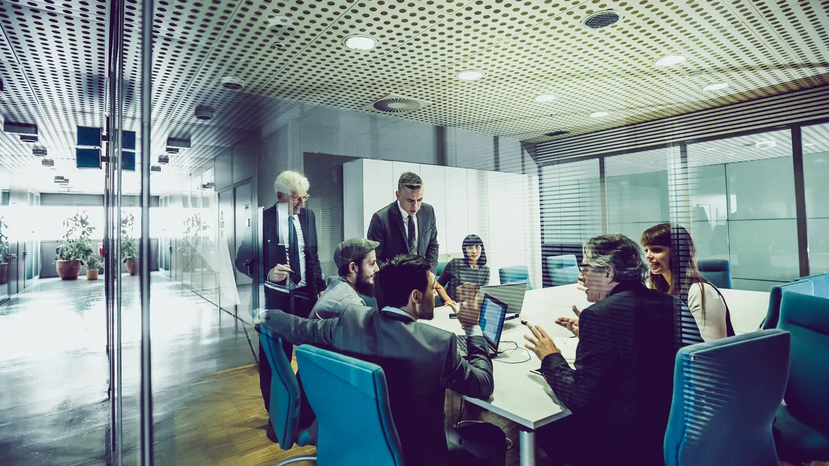 Business people in a conference room talking