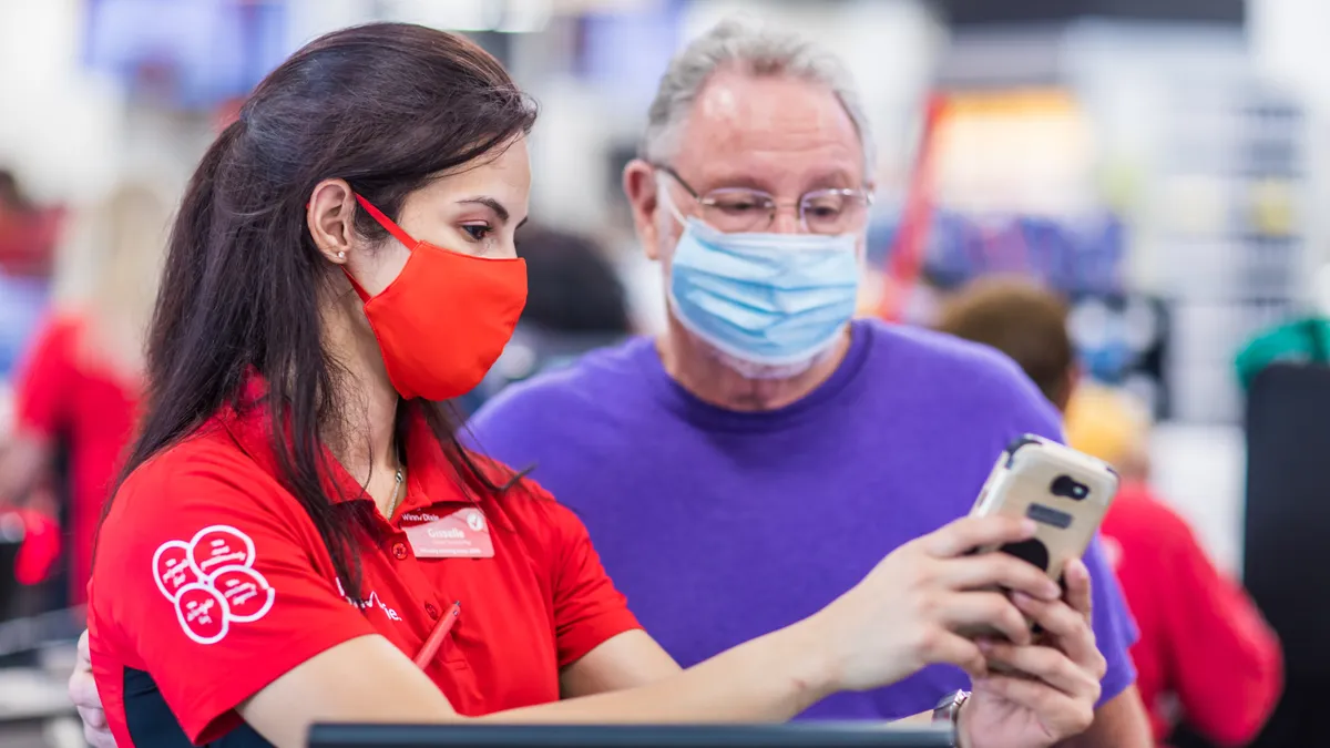 A Winn-Dixie employee helps a shopper