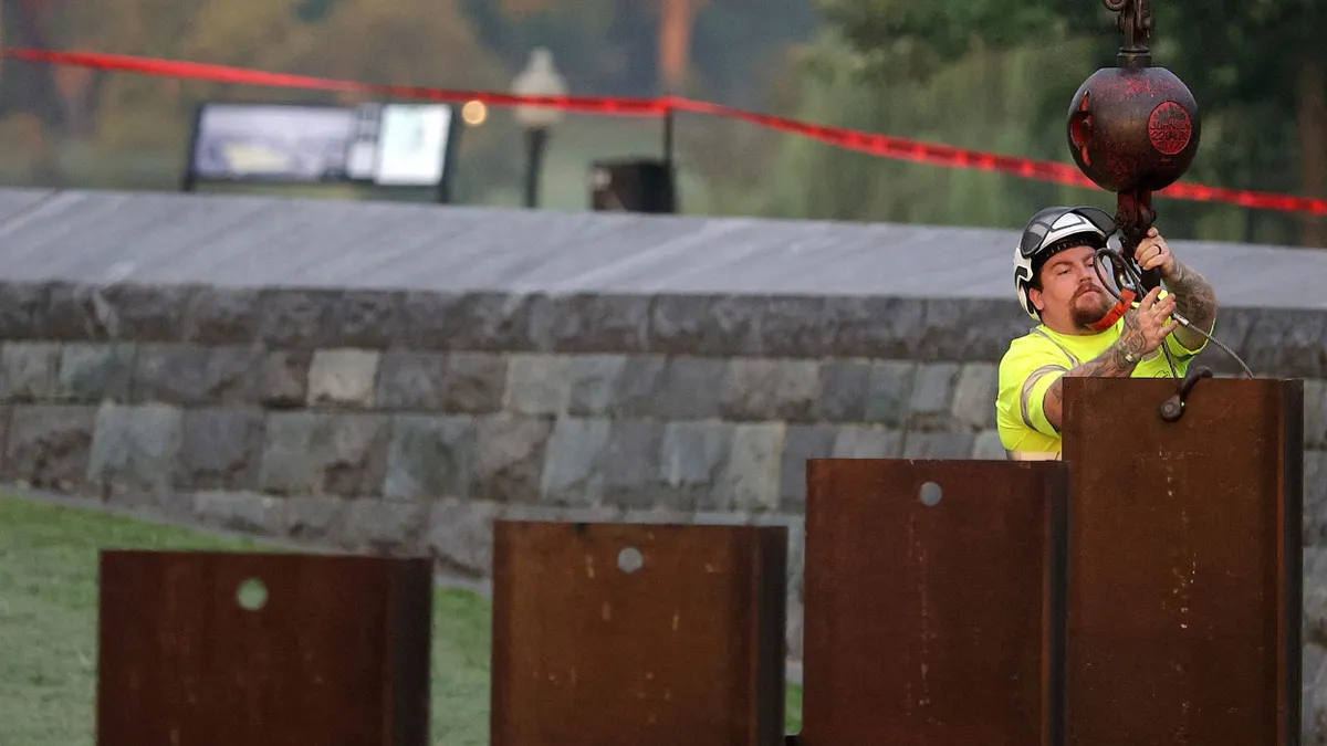 A worker tests an emergency levee.