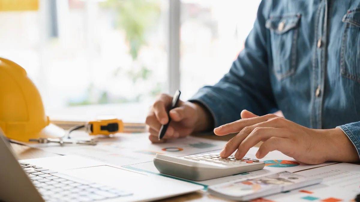 Man calculating budgets for construction projects.