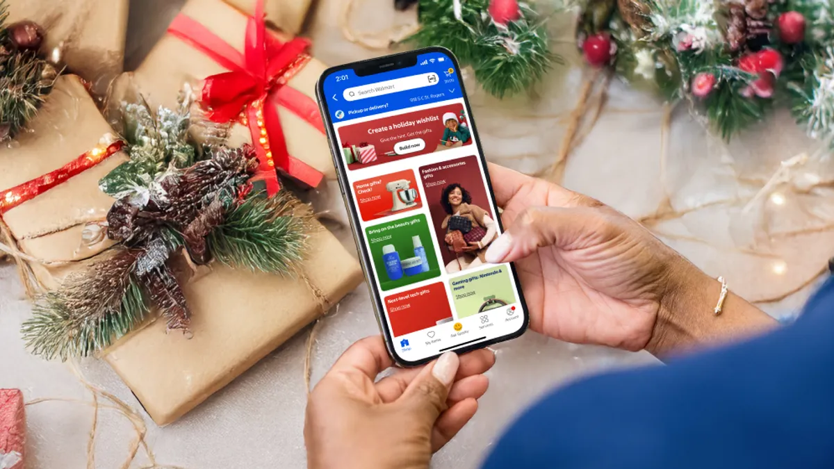 A customer uses the Walmart app in front of holiday decorations.