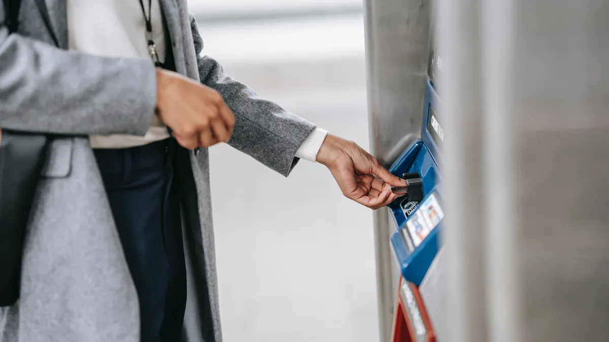 Woman stands at a machine