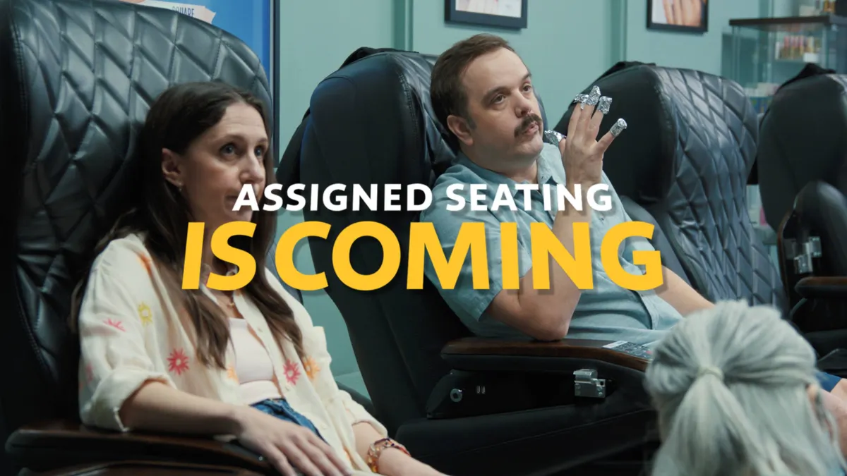 A couple sits on a pedicure chairs under text that reads "Assigned seating is coming" in an ad from Southwest Airlines