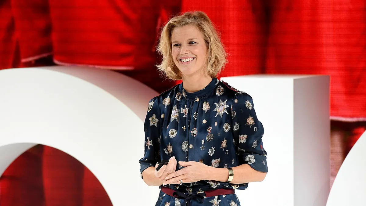 Avery Baker is pictured, smiling at a speaking event.