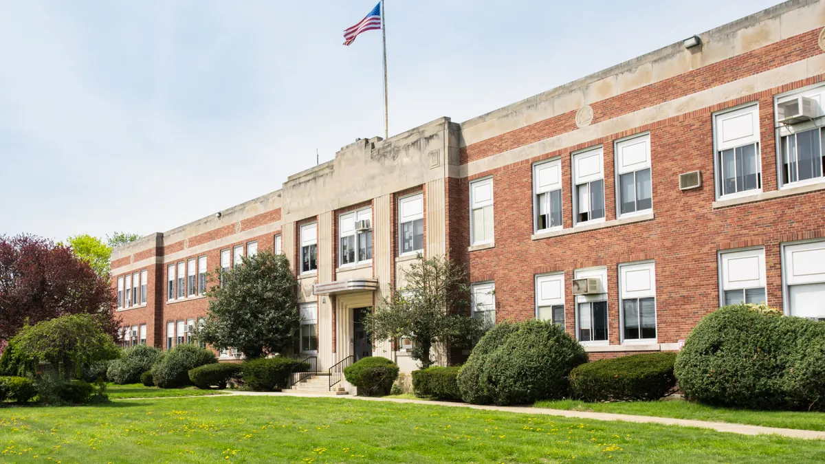 An exterior view of an American school building seen on a spring day.