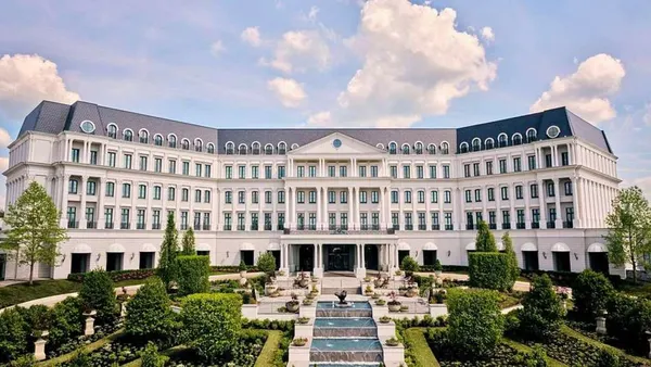 The exterior of Nemacolin, featuring a garden with fountains.