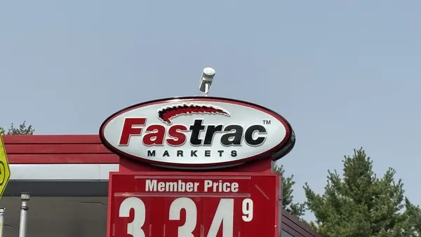 A sign outside a gas station. The sign says "Fastrac."