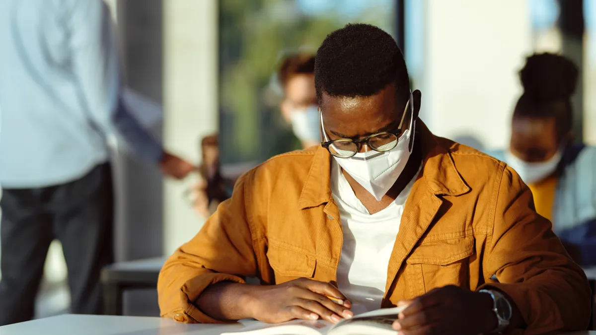 man studying while wearing a facemask