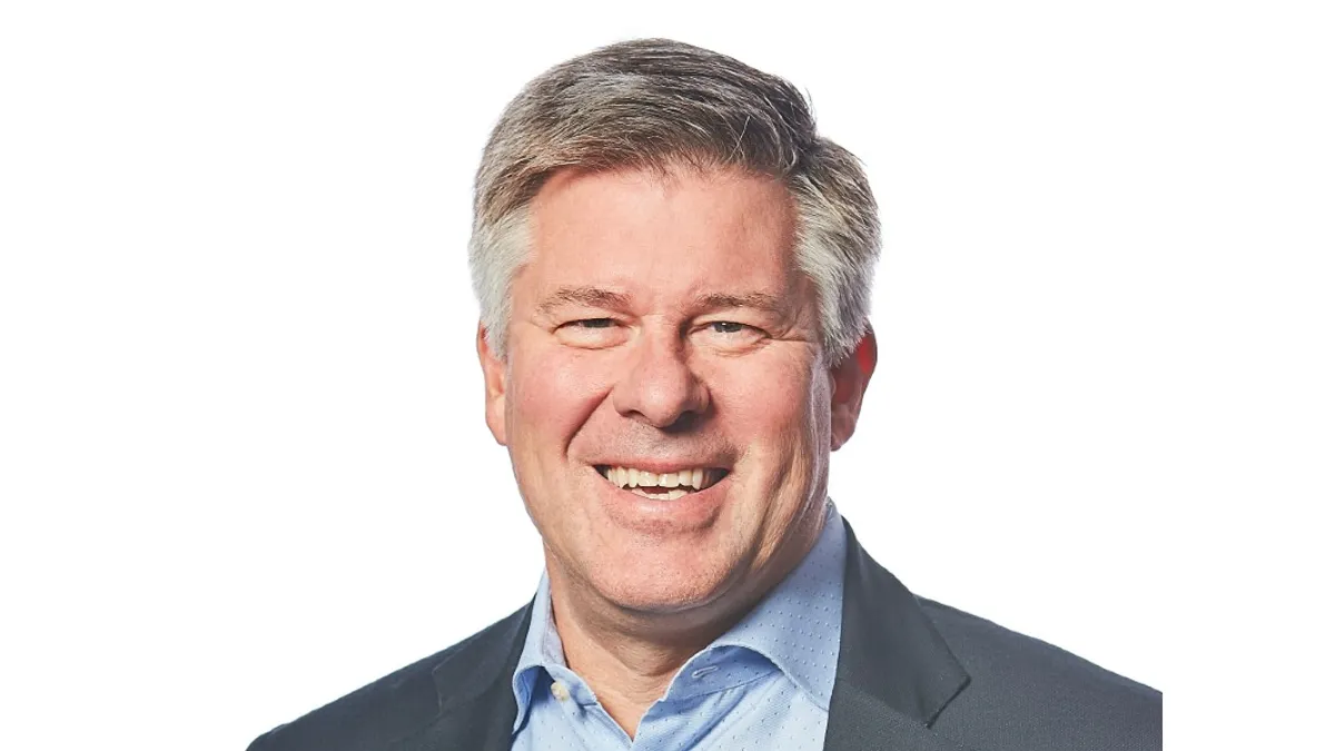 An image of a man wearing a suit in front of a white background.