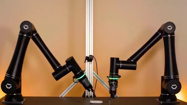 Standard Bots robotic arms demonstrate grabbing and picking up items.