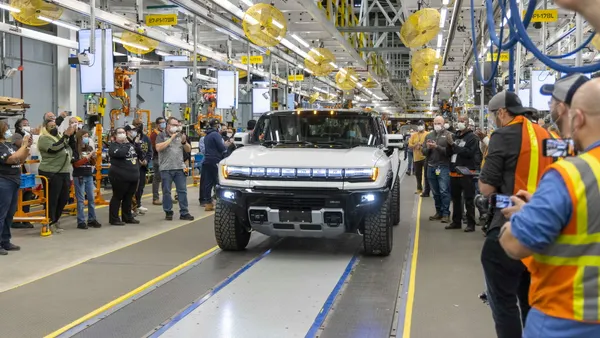 Workers assemble the GMC Hummer EV SUV.