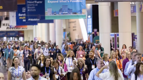 Attendees walking between sessions at a conference.