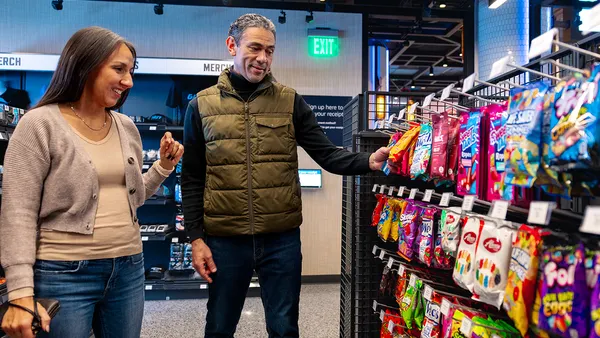 People standing by a candy isle
