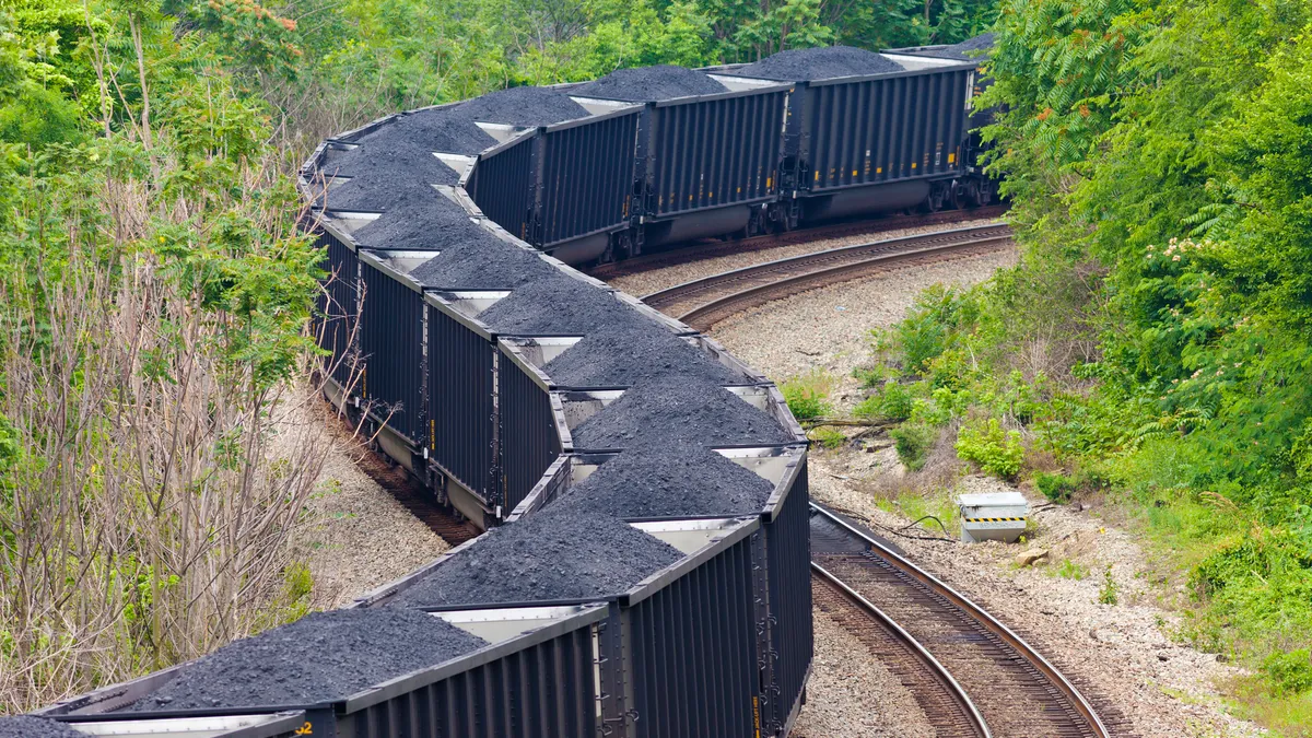 Close Up Of A Coal Train Winding Through The Forest.