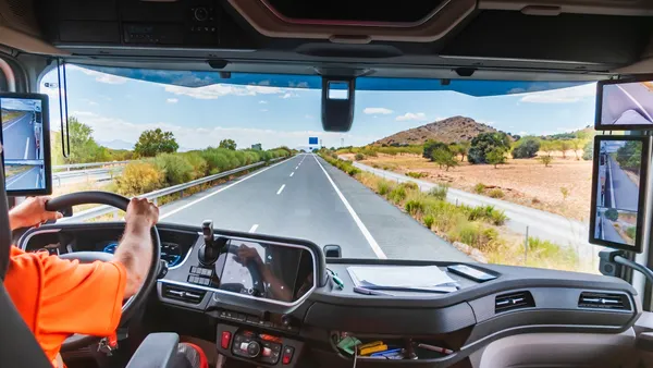 View of the interior of a state-of-the-art truck as it travels along the highway, where the driver receives all the information through the screens