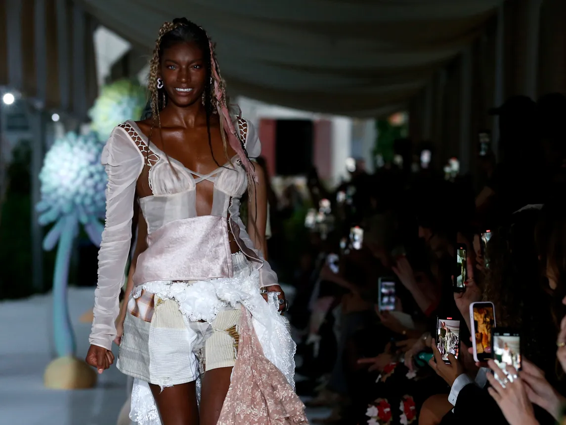 Models walk the runway smiling widely and while wearing hair ribbons and ballet-inspired clothing at the Collina Strada fashion show during New York Fashion Week, September 2023