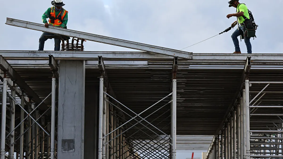 Construction workers help build a mixed-use apartment complex on January 25, 2024 in Los Angeles, Calif.