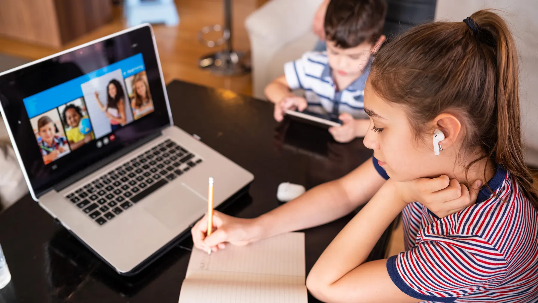 Teenage girl studying with video online lesson at home family in isolation covid-19. Homeschooling and distance learning