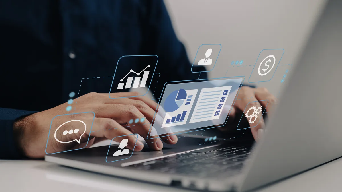 A man uses his business' customer relationship management system on a laptop.