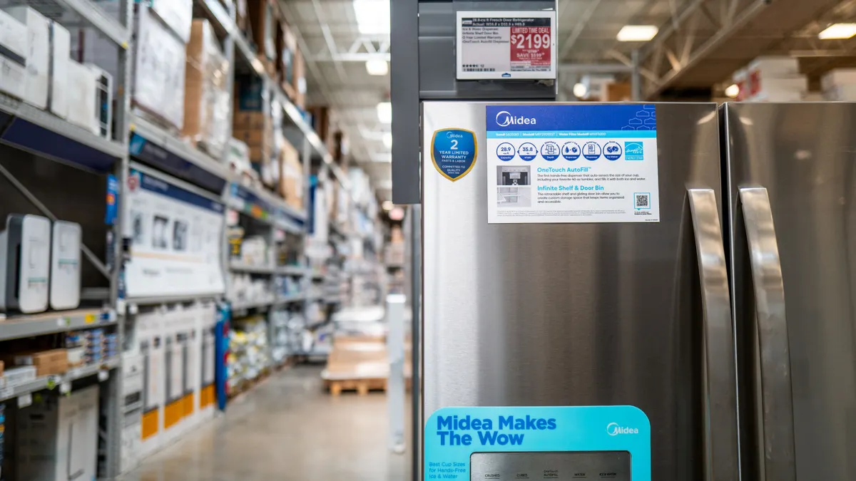 A refrigerator with an EPA Energy Star efficiency label stands in a Lowe's store.
