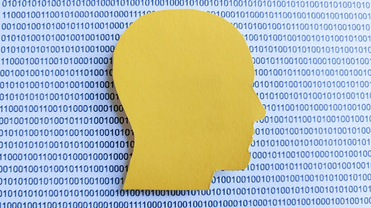 Image shows yellow silouhette of human head in foreground and binary code numbers in the background.