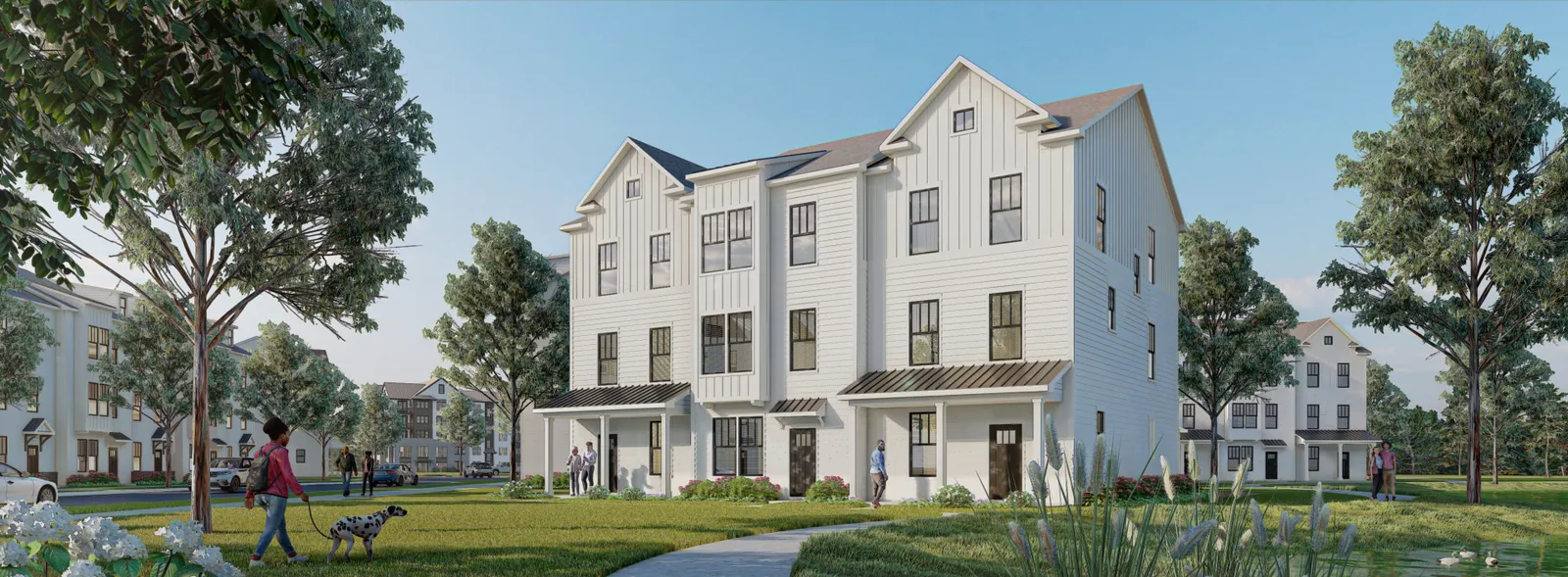 A row of white townhomes with peaked roofs.