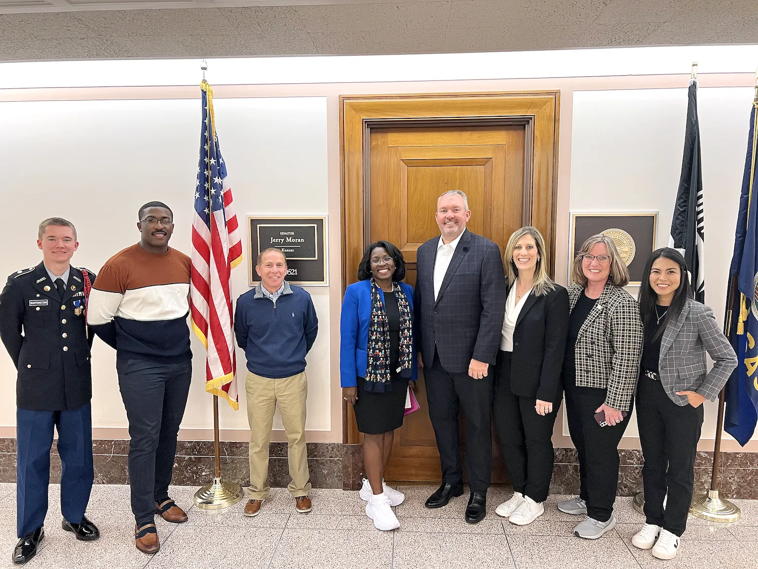 A group of students and educators from Topeka Public Schools stands in front of the office of Kansas Sen. Jerry Moran in Washington, D.C.