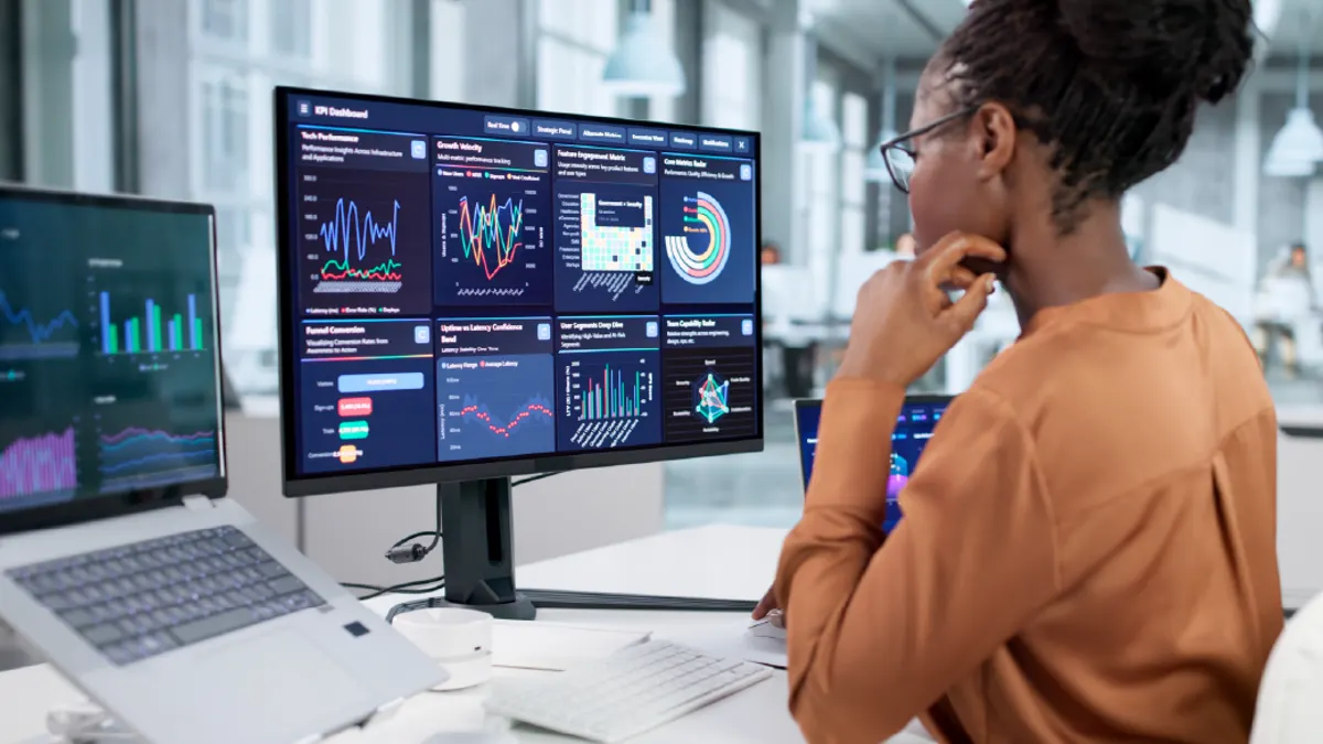 Female Data Analyst Analyzing Business Analytics On Computer