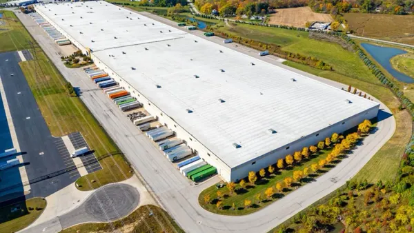 A fulfillment center in Ohio with freight container docked at the warehouse loading doors.