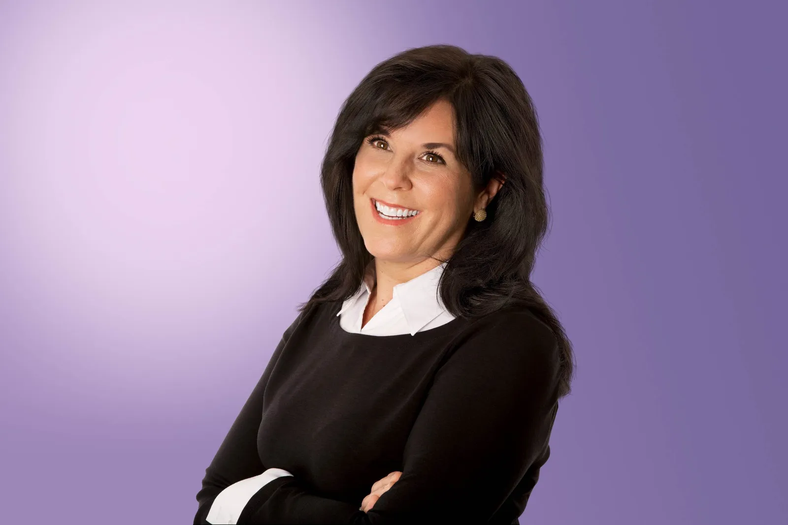 FCB Global Chief Data and Intelligence Officer Tina Allan wearing a black sweater and white shirt against a light purple background